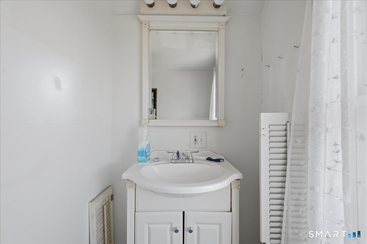 46 Hatch Street Stonington, CT 06355 - Photo 13 of 40 a bathroom with a sink and a mirror