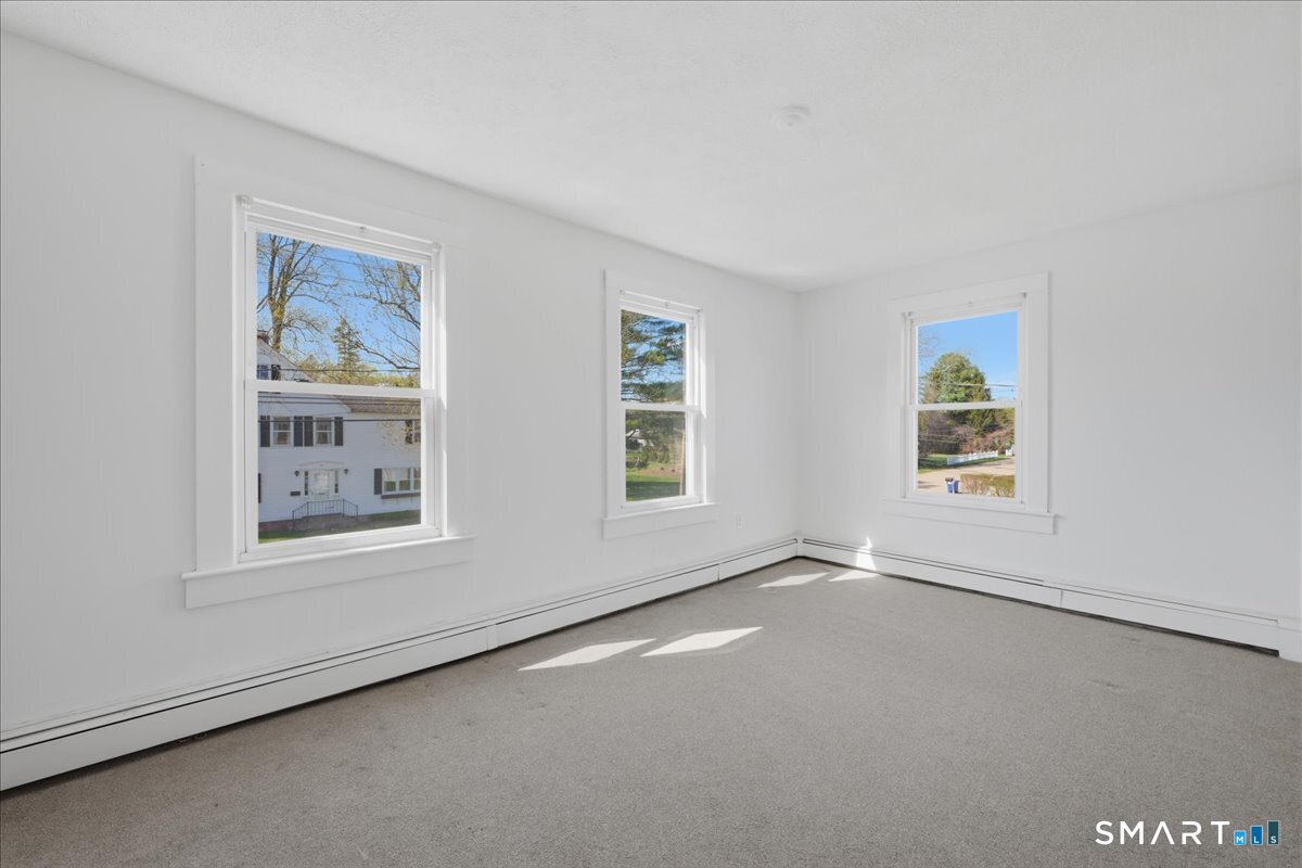 46 Hatch Street Stonington, CT 06355 - Photo 16 of 40 an empty room with windows