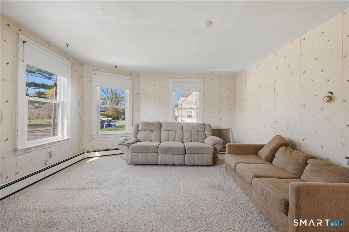 46 Hatch Street Stonington, CT 06355 - Photo 20 of 40 a living room with furniture and a window