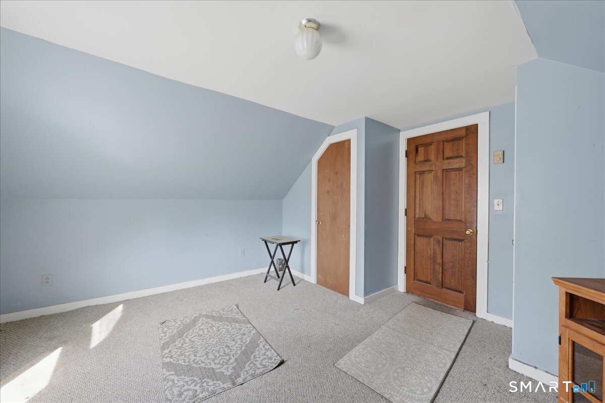 46 Hatch Street Stonington, CT 06355 - Photo 23 of 40 a view of a livingroom with wooden floor and a bathroom