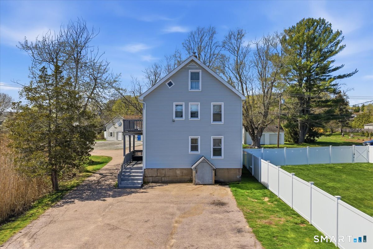 46 Hatch Street Stonington, CT 06355 - Photo 34 of 40 a view of a house with a yard and large tree