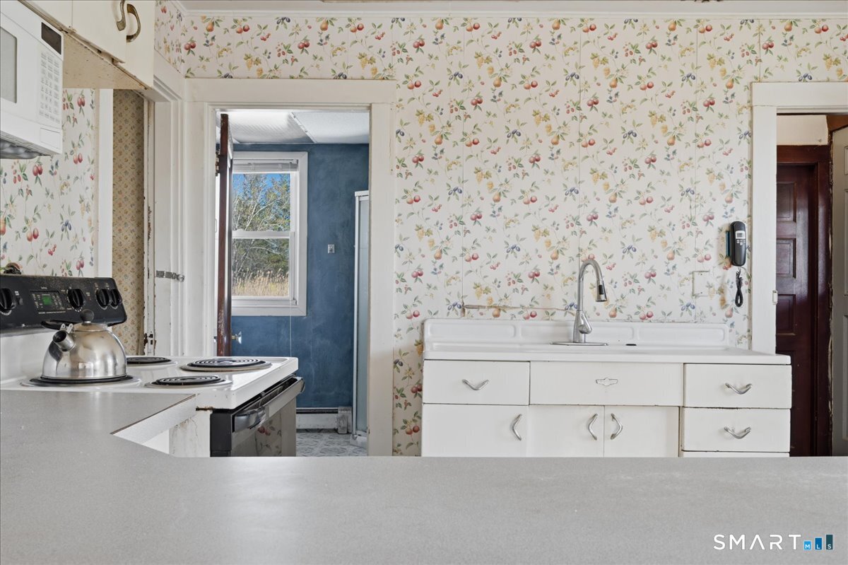 46 Hatch Street Stonington, CT 06355 - Photo 5 of 40 a bathroom with a sink and a mirror