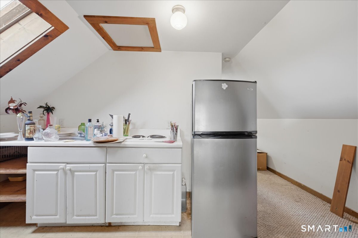 46 Hatch Street Stonington, CT 06355 - Photo 8 of 40 a kitchen with a refrigerator and cabinets