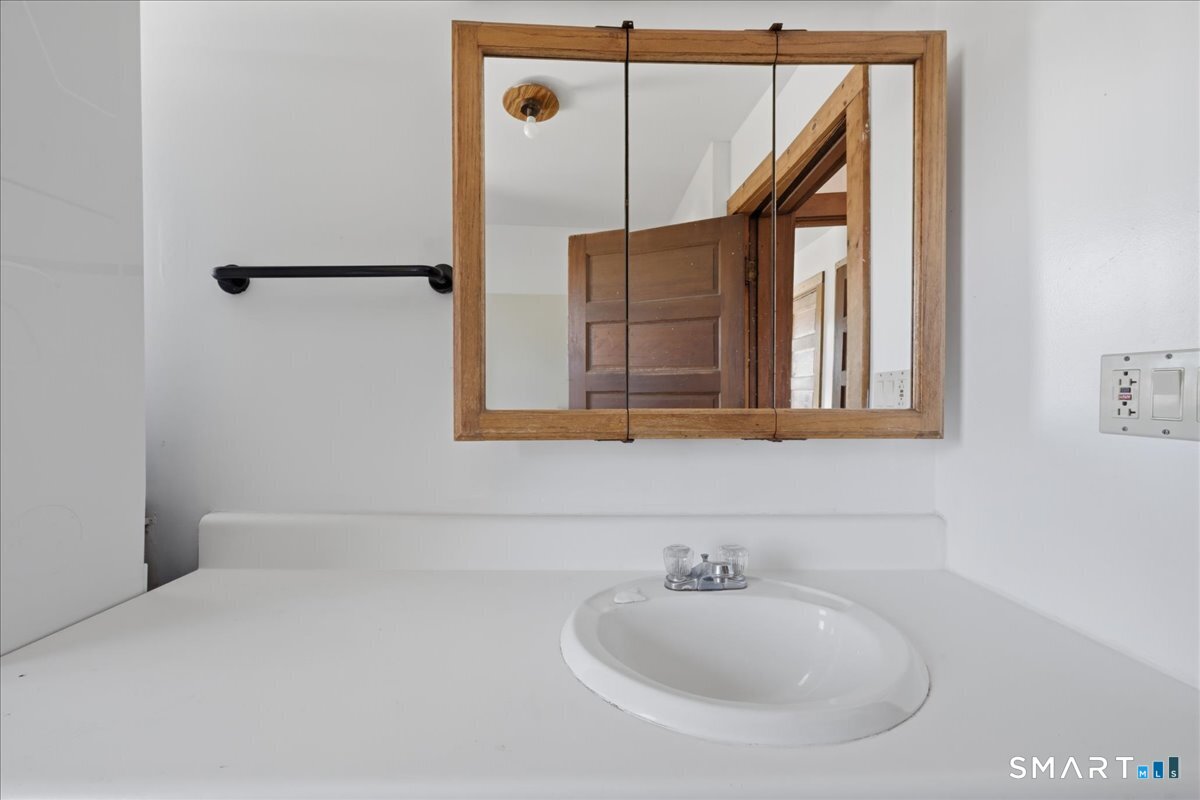 46 Hatch Street Stonington, CT 06355 - Photo 10 of 40 a bathroom with a sink and mirror