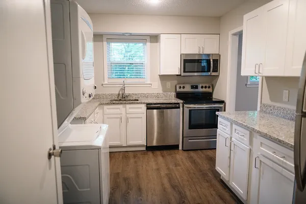a kitchen with a sink stove and microwave