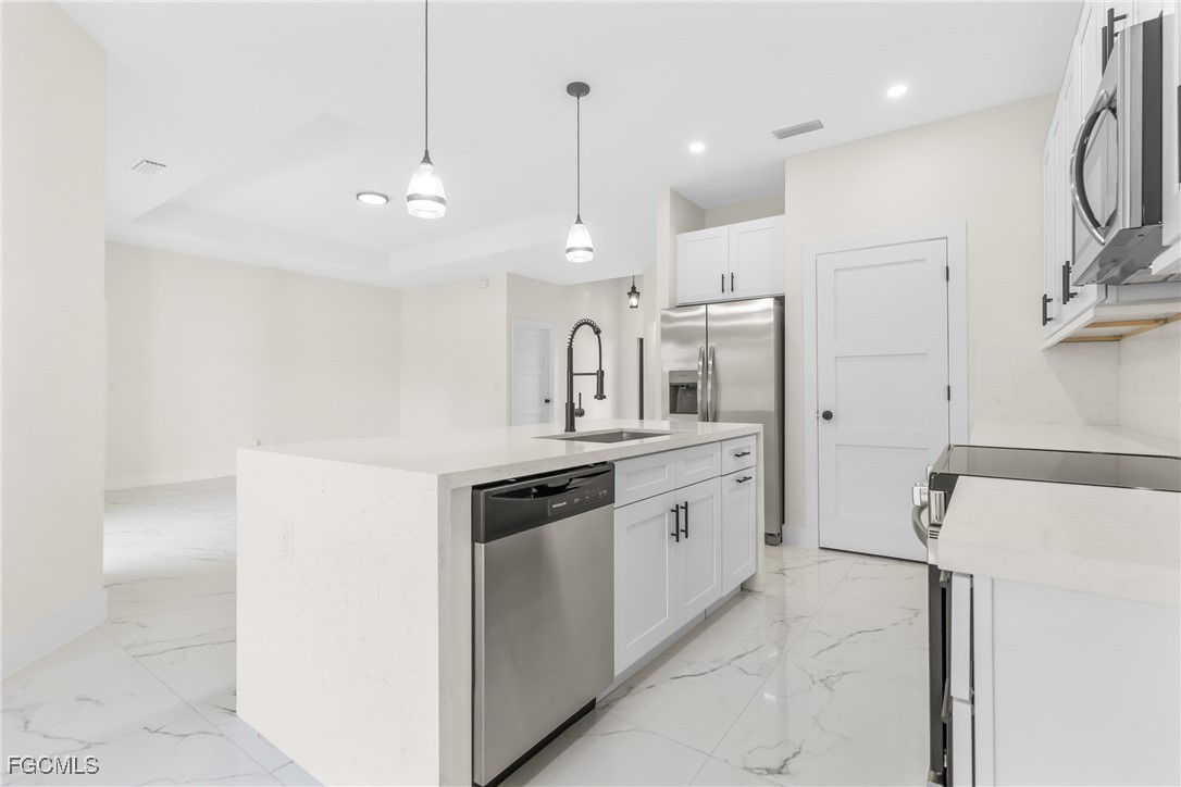 412 Fitch Avenue Lehigh Acres, FL 33972 - Photo 14 of 50 a kitchen with granite countertop a sink and a refrigerator