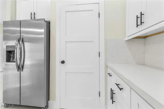 a kitchen with metallic refrigerator freezer and a dishwasher