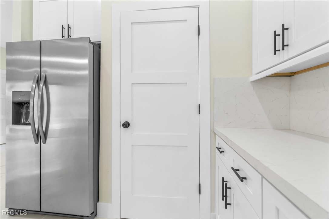 412 Fitch Avenue Lehigh Acres, FL 33972 - Photo 18 of 50 a kitchen with metallic refrigerator freezer and a dishwasher