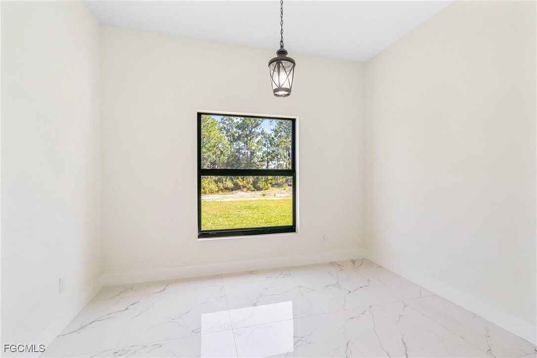 412 Fitch Avenue Lehigh Acres, FL 33972 - Photo 19 of 50 a view of an empty room with a window