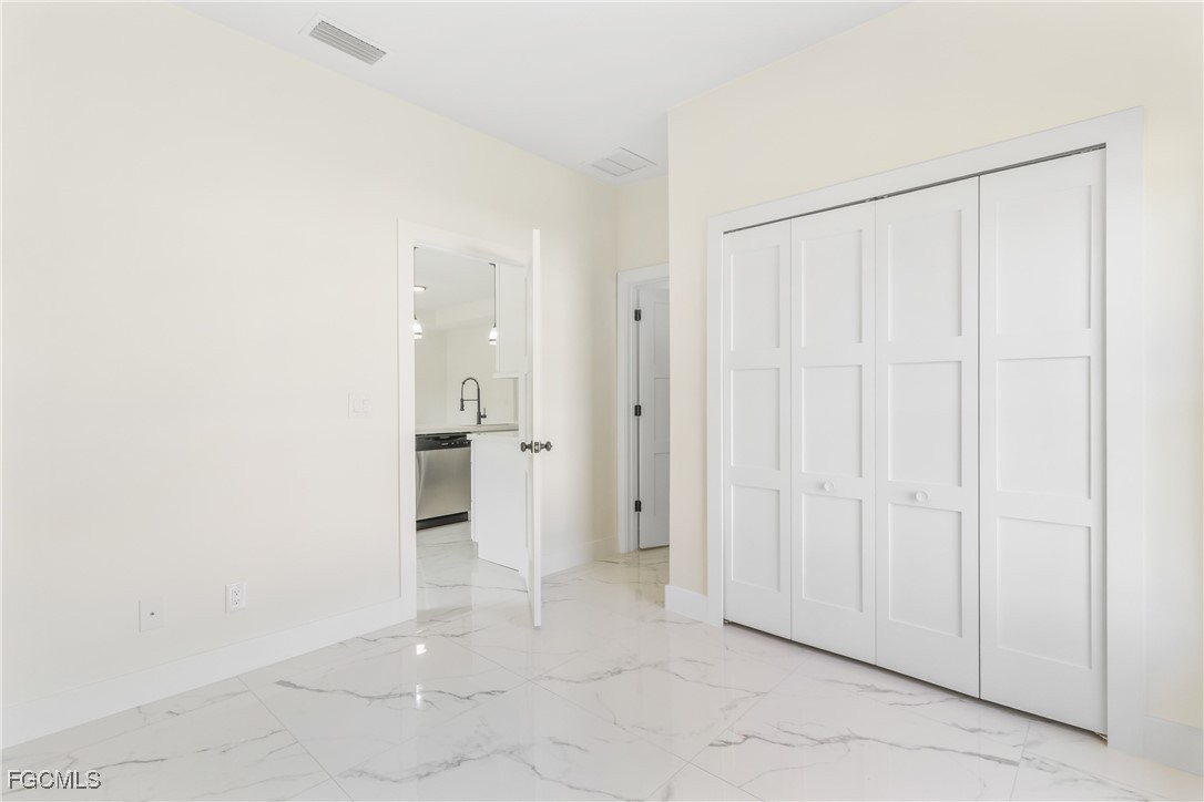 412 Fitch Avenue Lehigh Acres, FL 33972 - Photo 22 of 50 an empty room with a bathroom