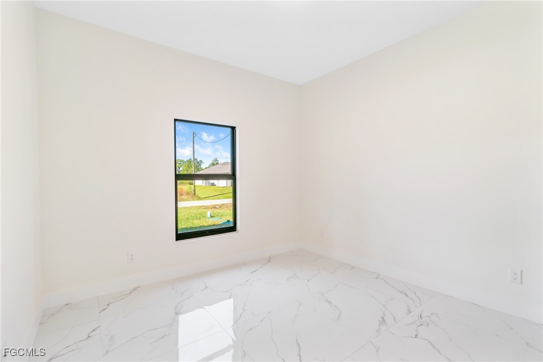412 Fitch Avenue Lehigh Acres, FL 33972 - Photo 27 of 50 an empty room with a window and a dresser