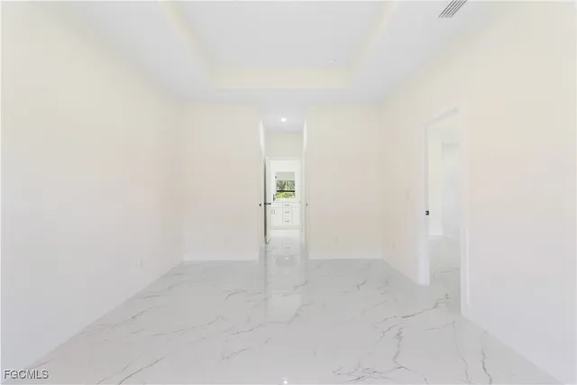 an empty room with windows and cabinet