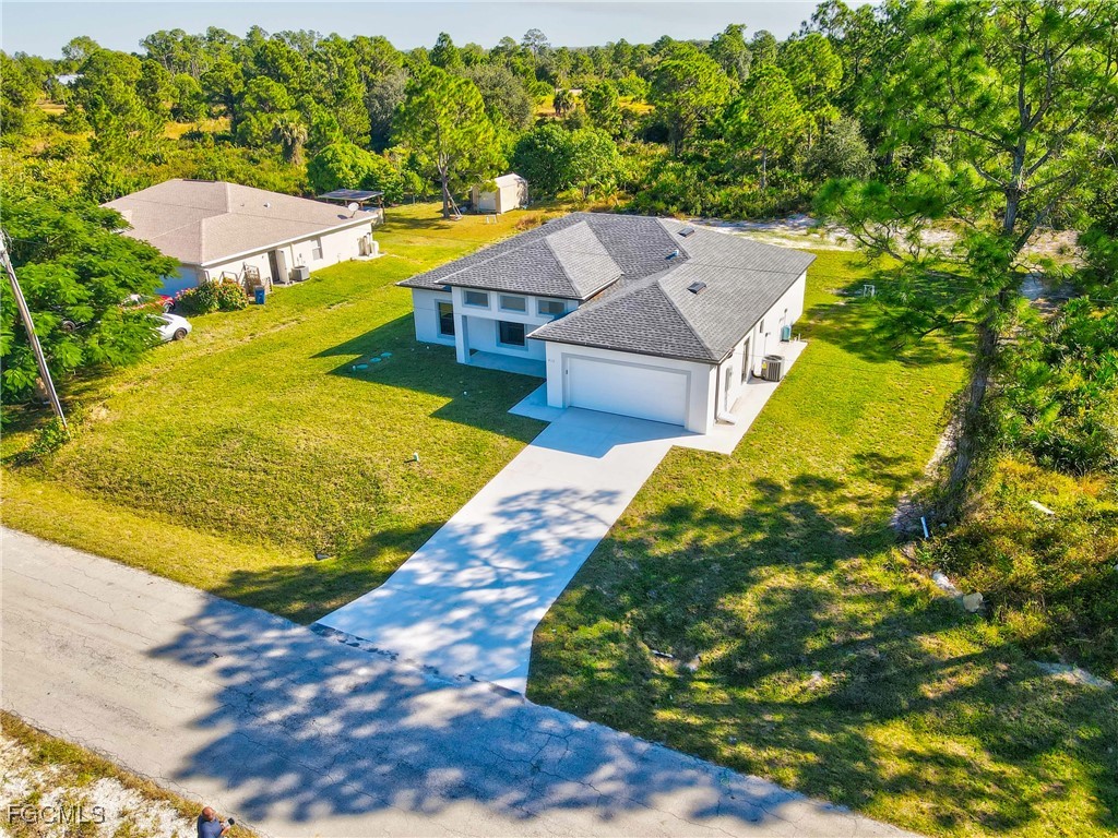 412 Fitch Avenue Lehigh Acres, FL 33972 - Photo 42 of 50 a view of a swimming pool with a yard
