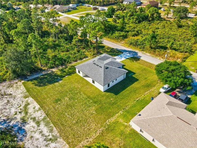 an aerial view of a house with a yard swimming pool outdoor seating and yard