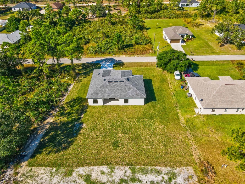 412 Fitch Avenue Lehigh Acres, FL 33972 - Photo 45 of 50 an aerial view of a house with a yard swimming pool outdoor seating and yard