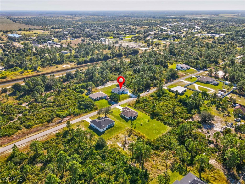 412 Fitch Avenue Lehigh Acres, FL 33972 - Photo 49 of 50 an aerial view of residential houses with outdoor space and trees