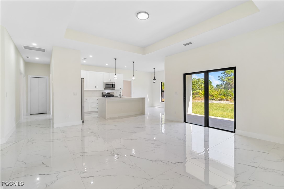 412 Fitch Avenue Lehigh Acres, FL 33972 - Photo 9 of 50 a view of a livingroom with kitchen furniture and windows
