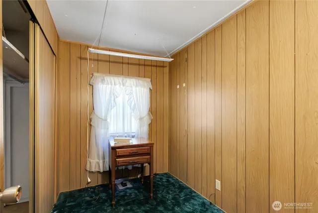 a view of a bathroom with a window and a chair