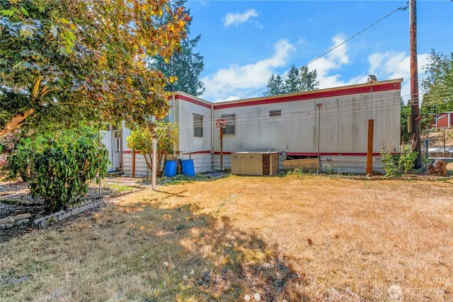 a backyard of a house with a tree