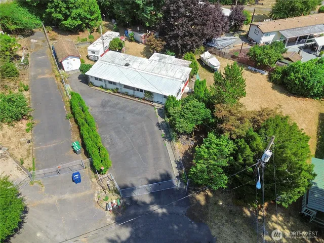 an aerial view of a house with a yard and garden