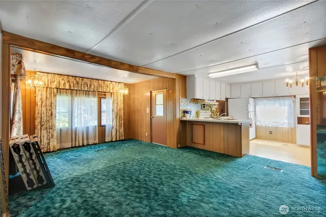 a view of kitchen with refrigerator and window