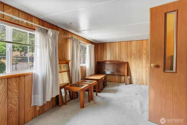 a view of a hallway with furniture and a window