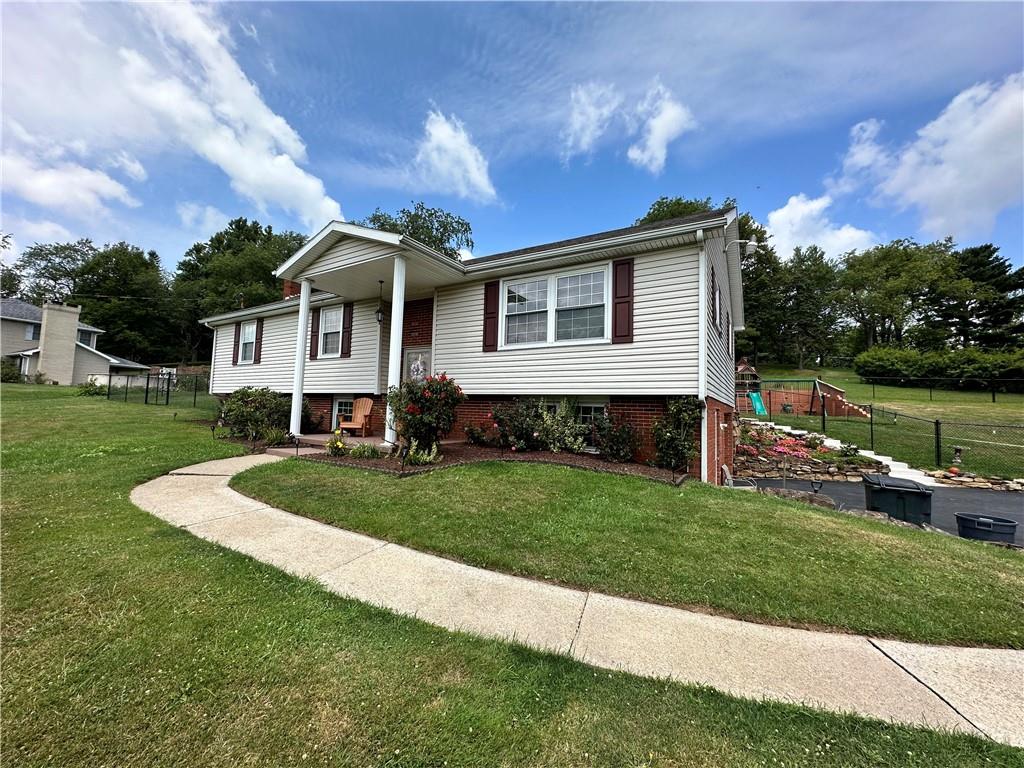 3021 Langley Road Uniontown, PA 15401 - Photo 1 of 28 a front view of a house with a garden and yard