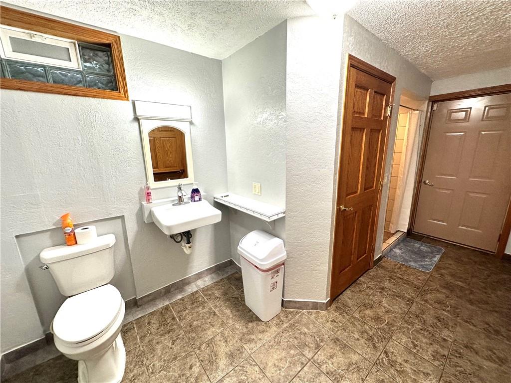 3021 Langley Road Uniontown, PA 15401 - Photo 12 of 28 a bathroom with a toilet sink and mirror