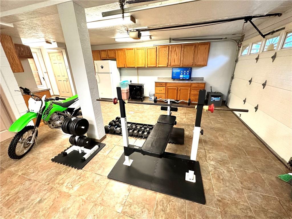 3021 Langley Road Uniontown, PA 15401 - Photo 19 of 28 a room with gym equipment and a potted plant