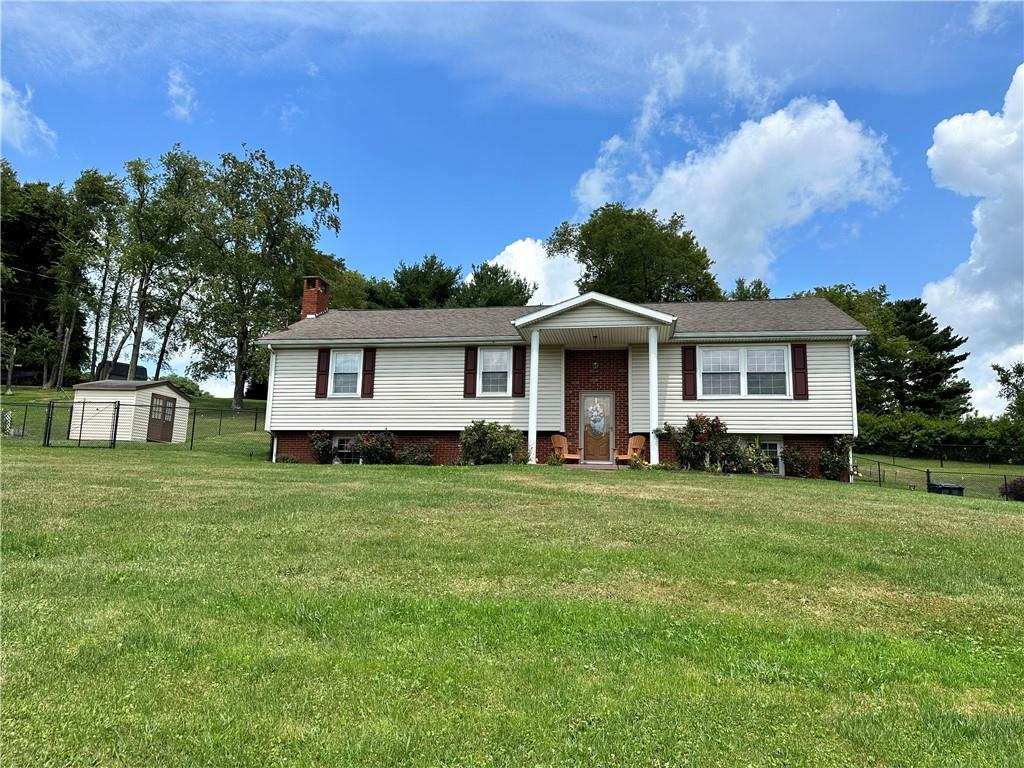 3021 Langley Road Uniontown, PA 15401 - Photo 2 of 28 a front view of a house with a garden