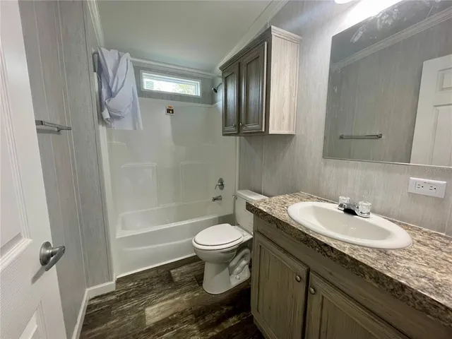 a bathroom with a tub sink and mirror