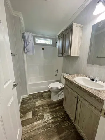 a white bath tub sitting in a bathroom next to a window