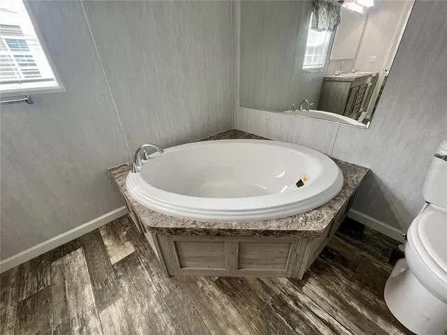 a view of a livingroom with wooden floor and closet