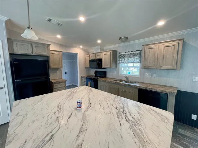 a kitchen with a stove and a sink