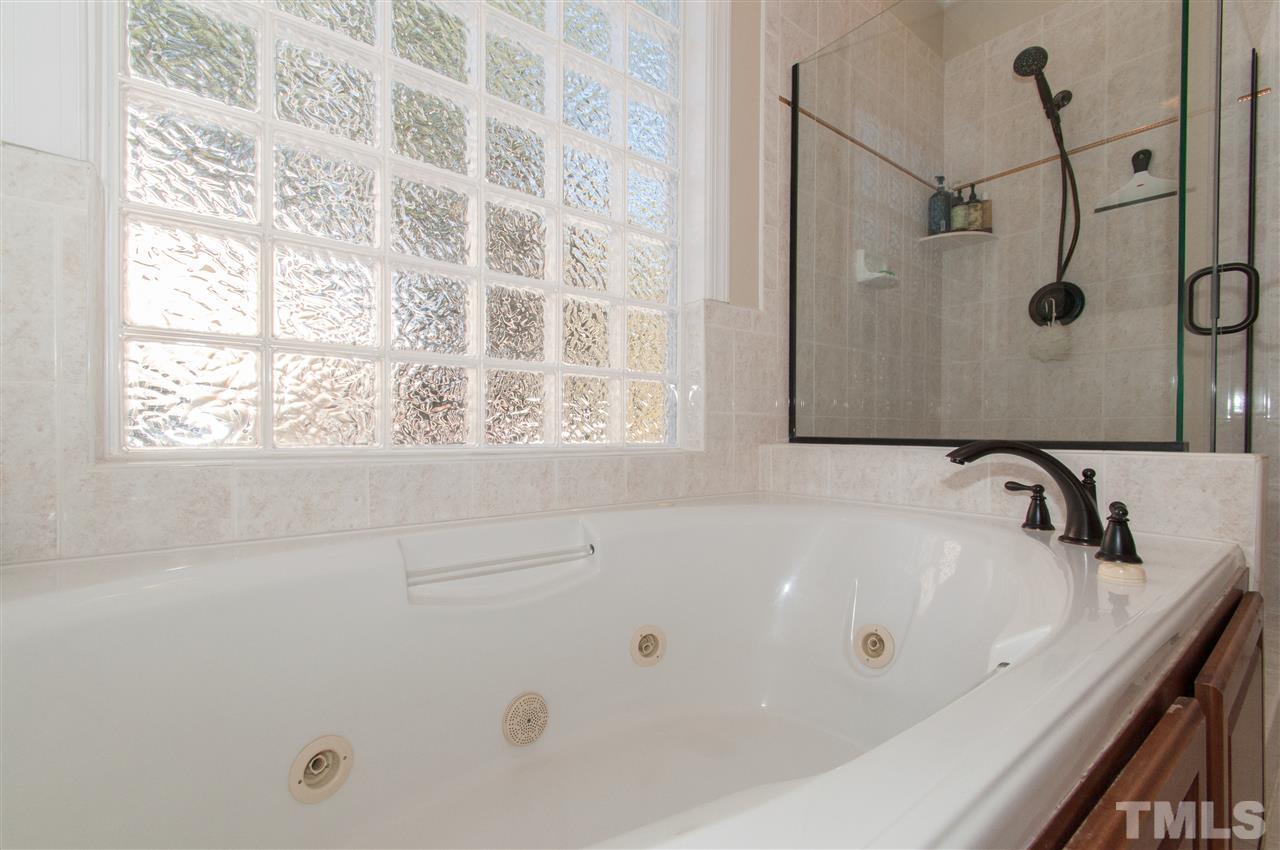 200 Release Circle Raleigh, NC 27615 - Photo 11 of 25 a bathroom with a tub and a shower