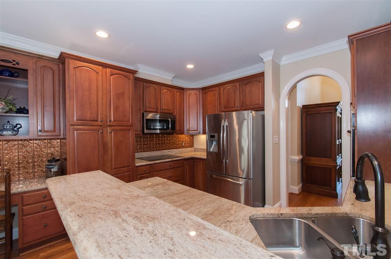200 Release Circle Raleigh, NC 27615 - Photo 5 of 25 a kitchen with stainless steel appliances granite countertop a refrigerator and a sink
