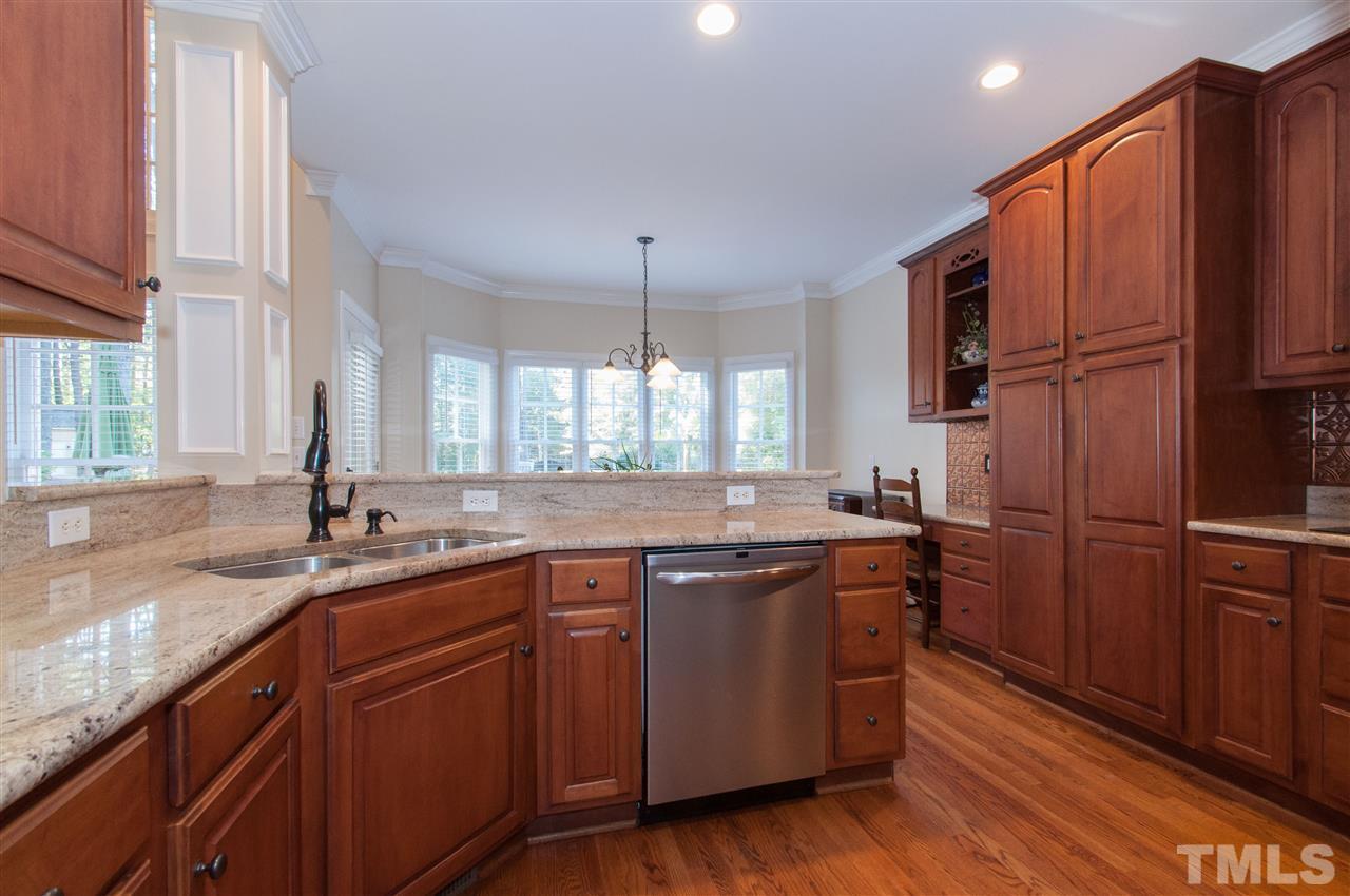 200 Release Circle Raleigh, NC 27615 - Photo 6 of 25 a kitchen with stainless steel appliances granite countertop wooden floors and sink