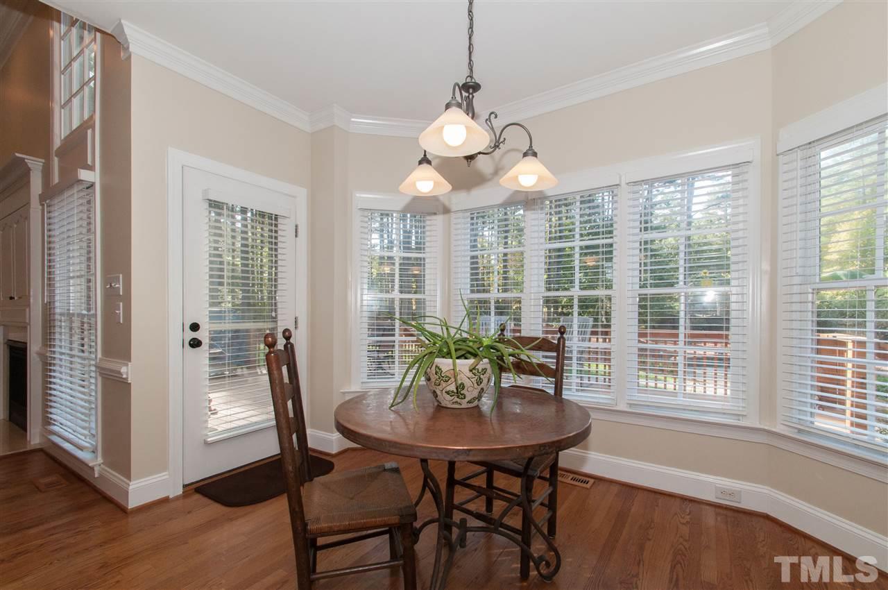 200 Release Circle Raleigh, NC 27615 - Photo 8 of 25 a view of a dining room with furniture wooden floor and chandelier