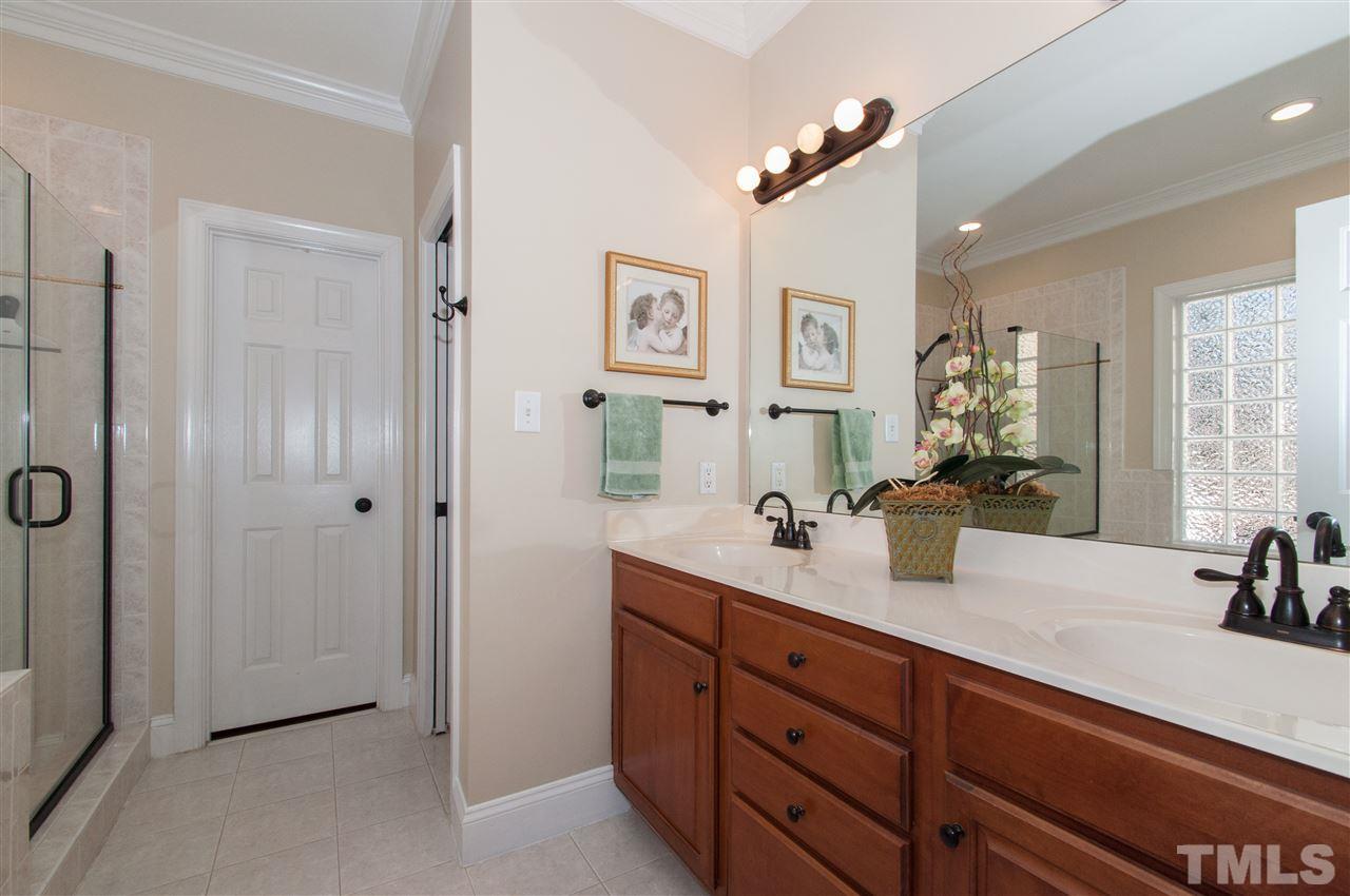 200 Release Circle Raleigh, NC 27615 - Photo 10 of 25 a bathroom with double vanity sinks a vanity and a large mirror
