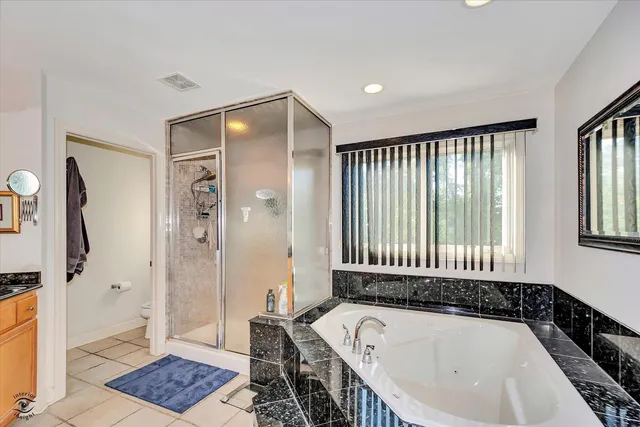 a bathroom with a bathtub and a shower