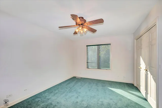 a view of a room with a window and a fan