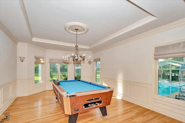 a room with pool table and windows