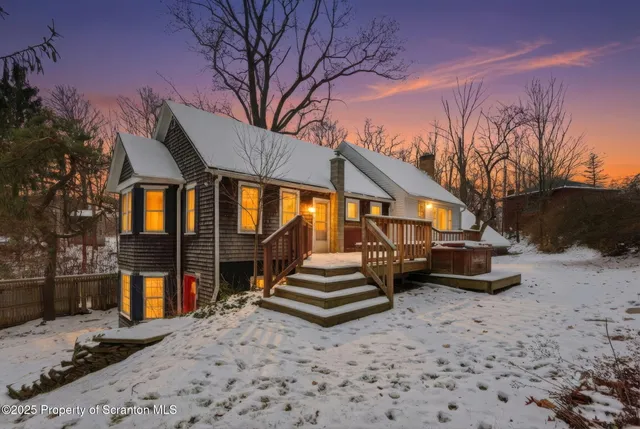 a backyard of a house with barbeque oven and outdoor seating