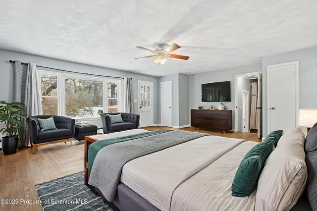 a bedroom with a bed and a potted plant