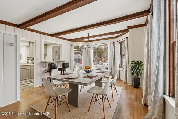 a view of a livingroom with wooden floor and stairs