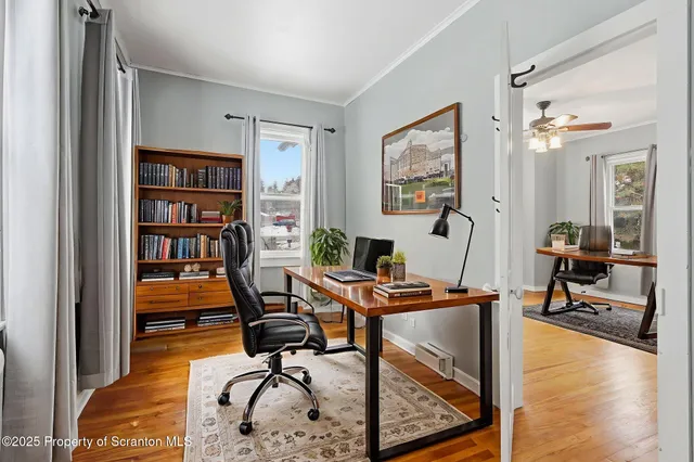 a view of a livingroom with wooden floor and stairs