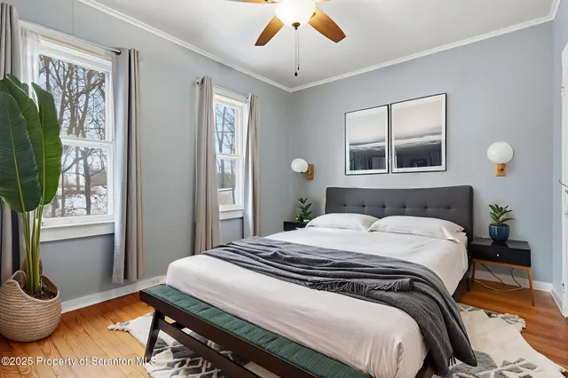 a view of a livingroom with wooden floor and a fireplace