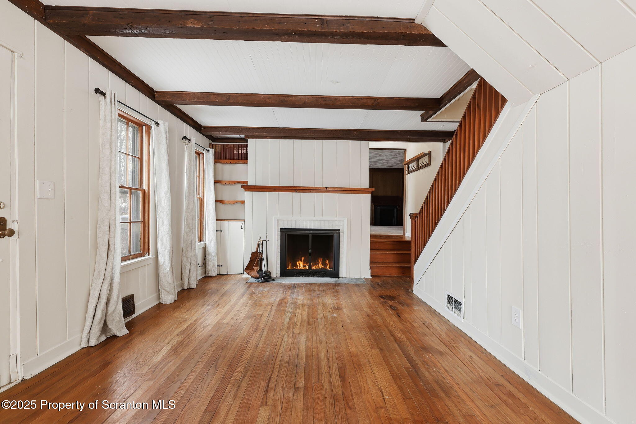 2457 Airport Road Forest City, PA 18421 - Photo 23 of 78 a view of a livingroom with wooden floor and a fireplace