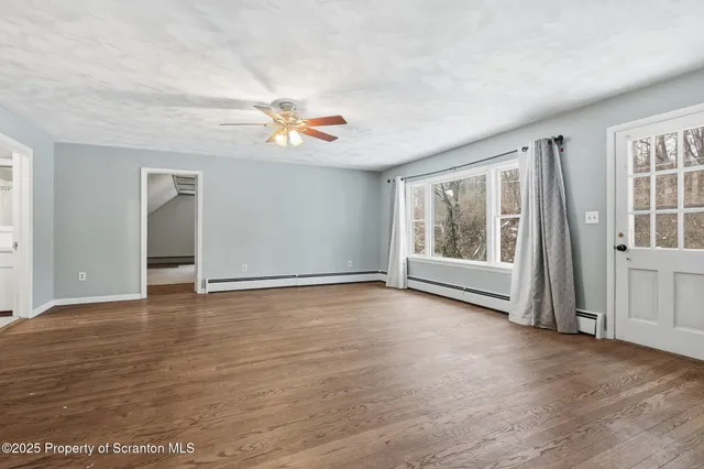 a view of livingroom with hardwood floor and ceiling fan