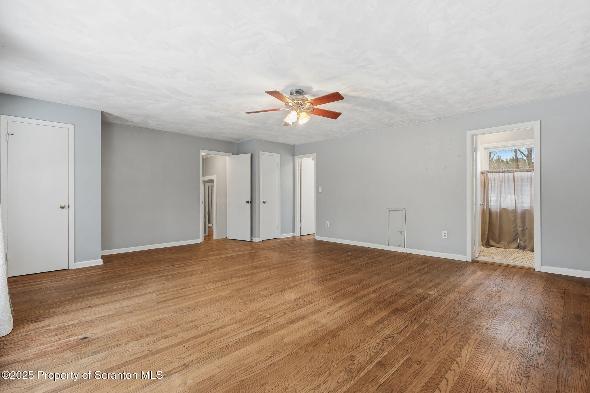 2457 Airport Road Forest City, PA 18421 - Photo 35 of 78 a view of an empty room with chandelier fan and wooden floor